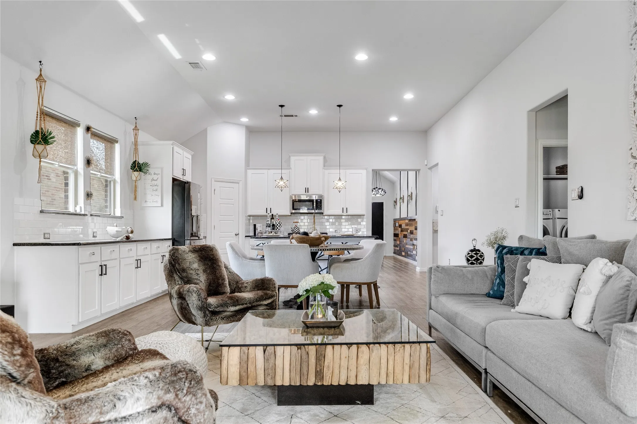 Open-concept living area featuring high ceilings, recessed lighting, and wood-finish flooring
