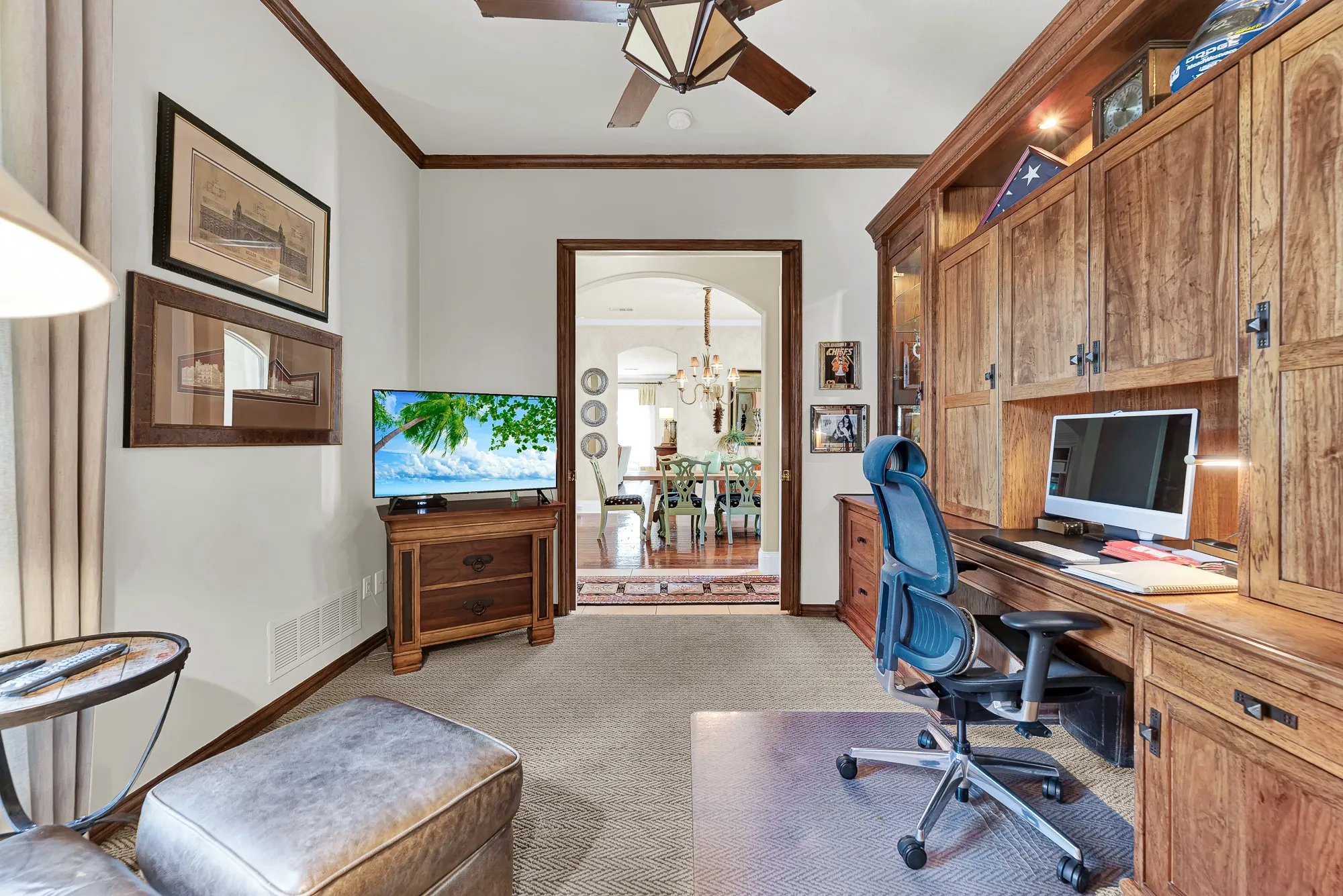 Warm wood paneling, a geometric ceiling fan, and a wide doorway opening to the main living areas showcase the smooth flow of this first-floor space. Guests will appreciate the effortless balance of privacy and connection when staying on the main level.