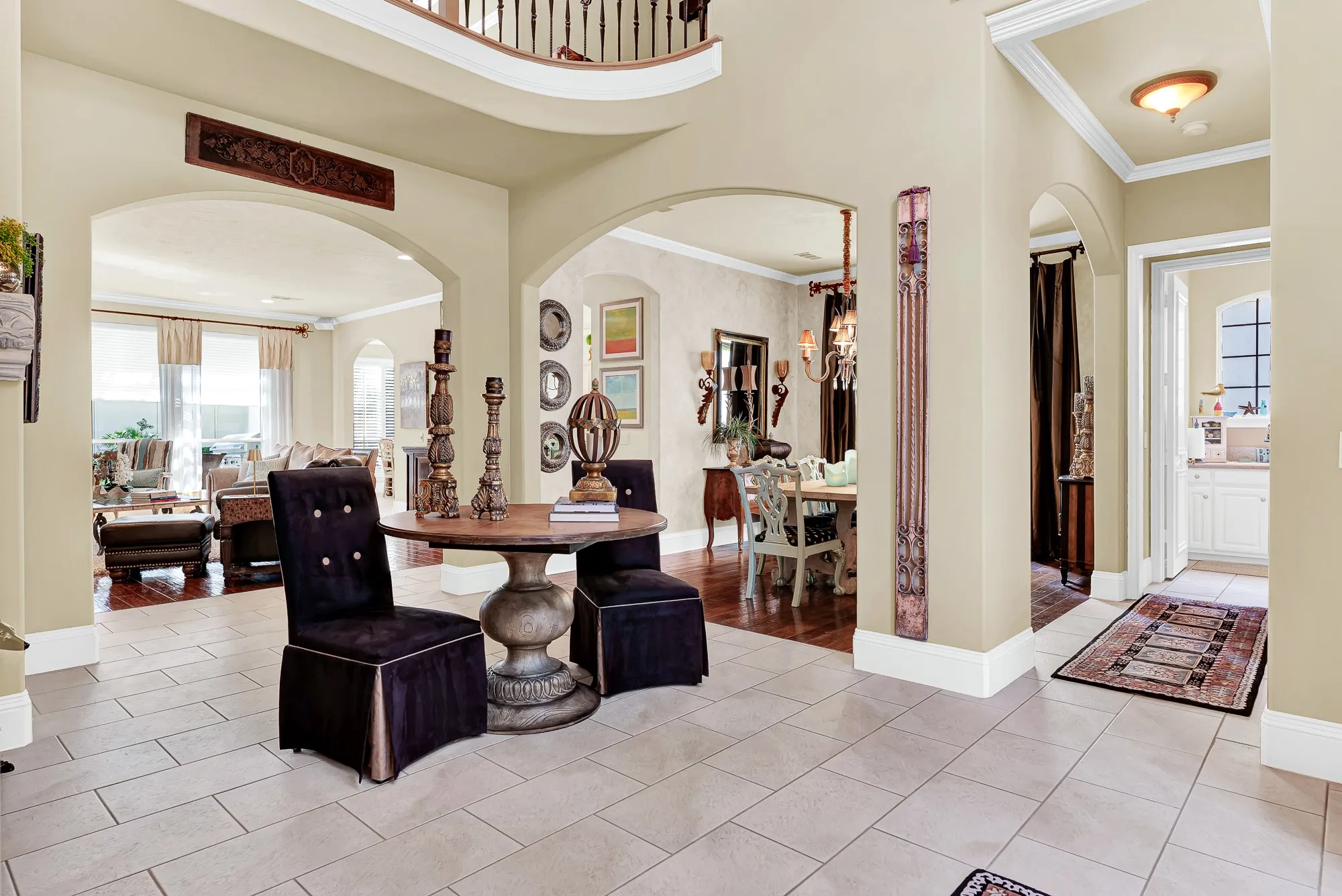 Wide arched doorways flow seamlessly from the entry into the formal dining and open main living areas, framed by clean tile flooring. You will love how naturally this layout draws friends deeper into your home during dinner parties and weekend get-togethers.