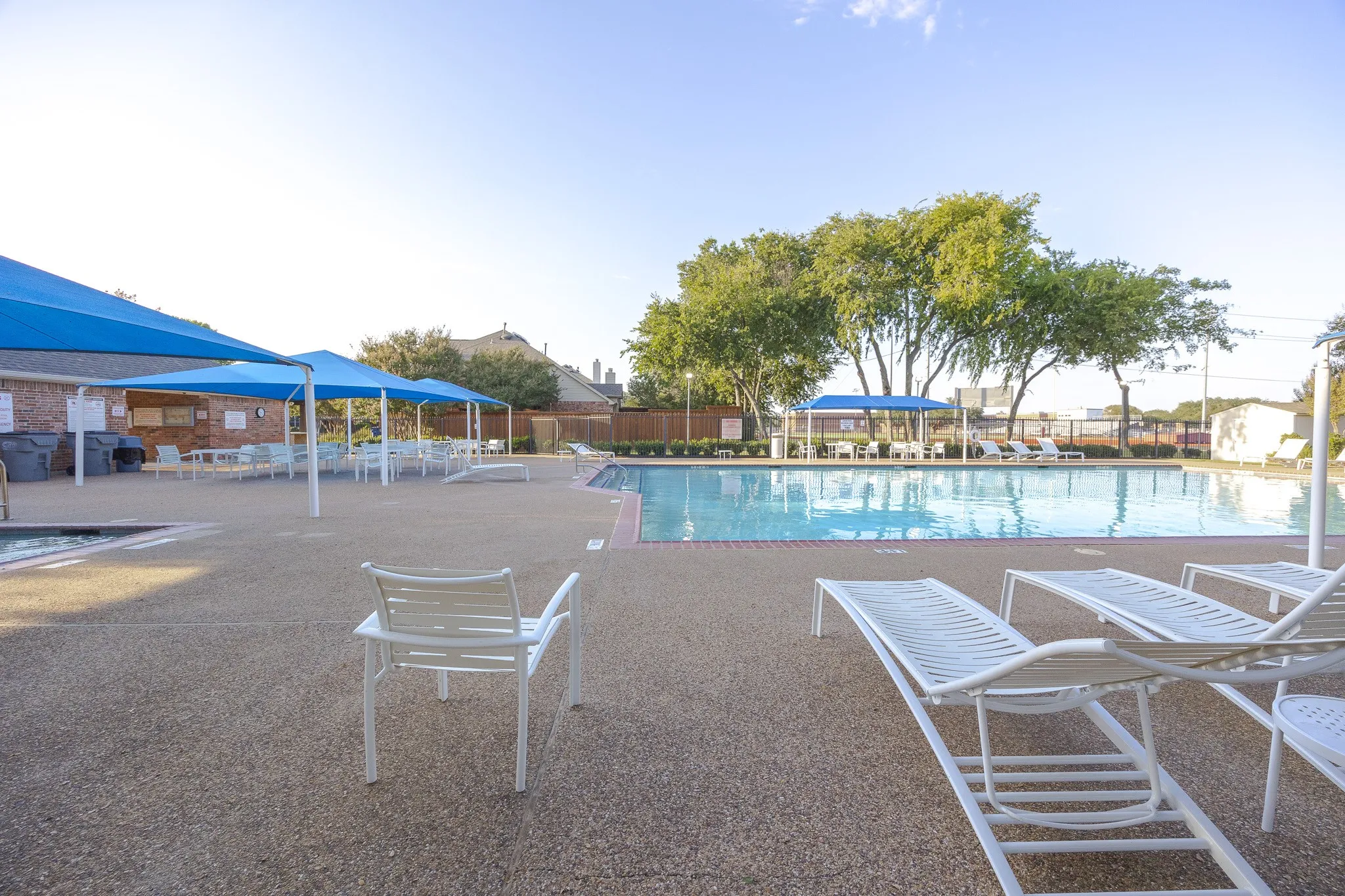 Expansive outdoor pool with a surrounding textured concrete deck