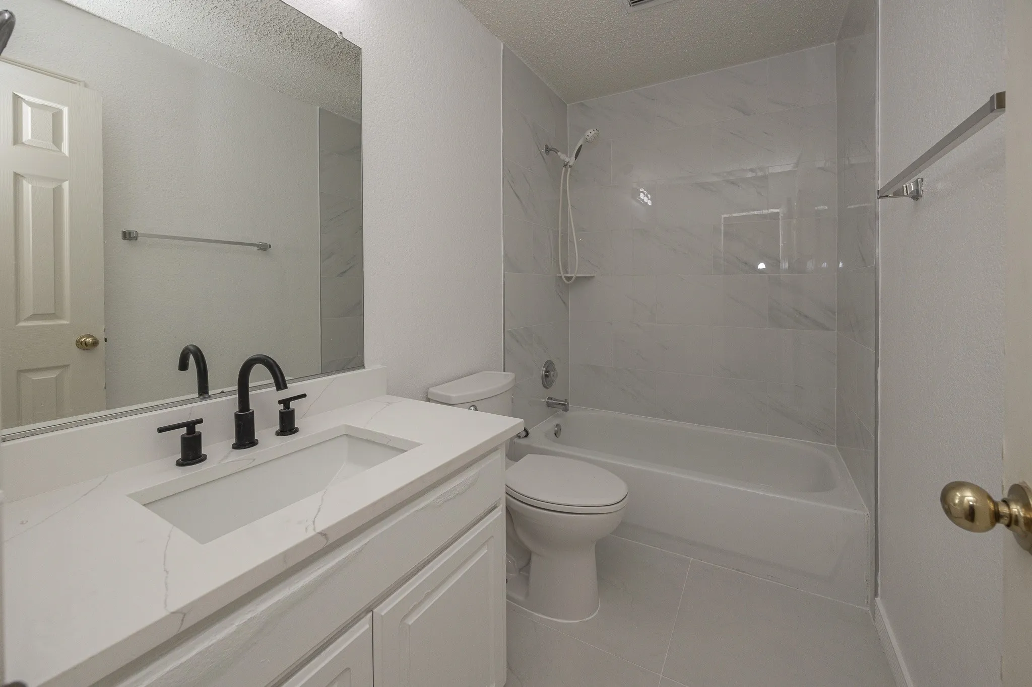 Vanity with white countertop, integrated sink, and matte black fixtures
