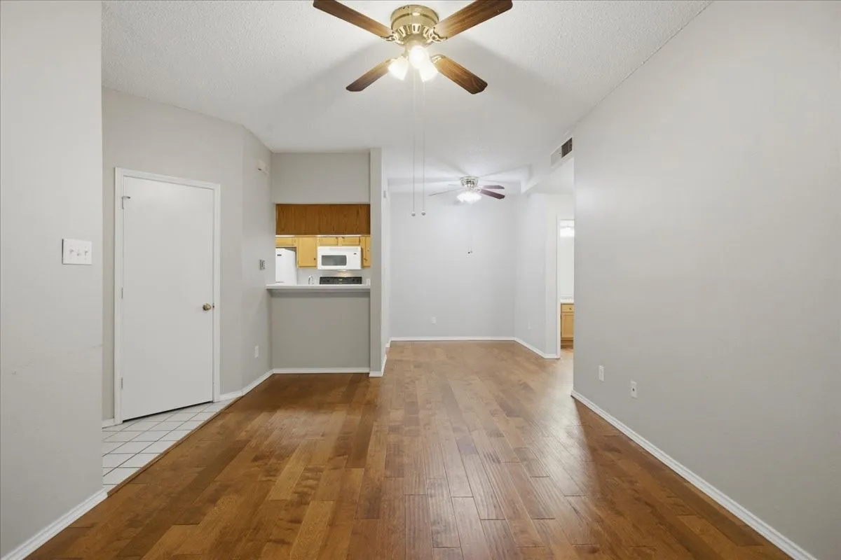 Dining space and kitchen serving bar with coat closet at the entry (unstaged)