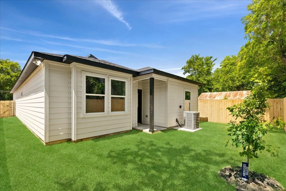 Manicured lawn, wood fencing, and neutral exterior siding