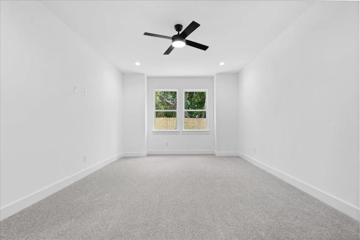 Recessed lighting, light gray carpeting, and a black ceiling fan with an integrated light fixture