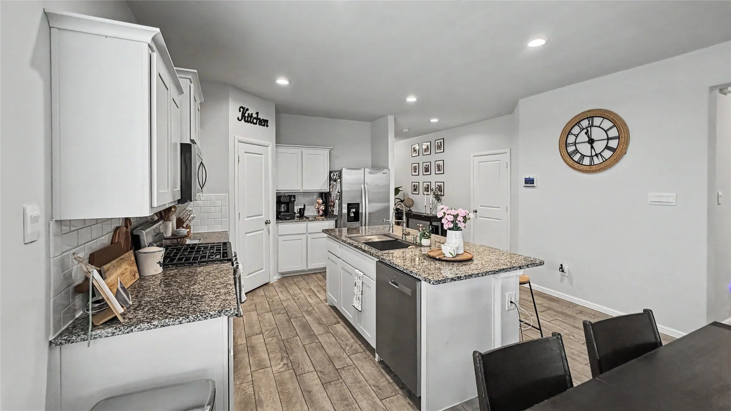 The heart of the home, this spacious kitchen features beautiful granite countertops, crisp white cabinetry.