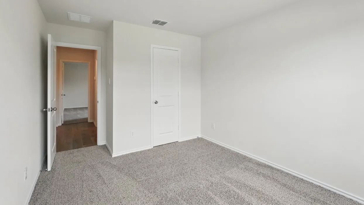 Neutral wall color, carpeted flooring, and a two-panel interior door
