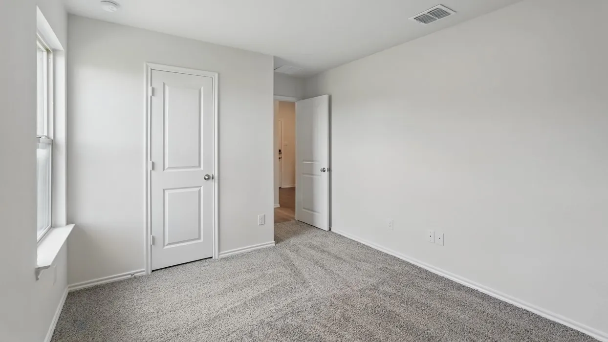Light gray carpeting, white walls, and a single window with a white sill