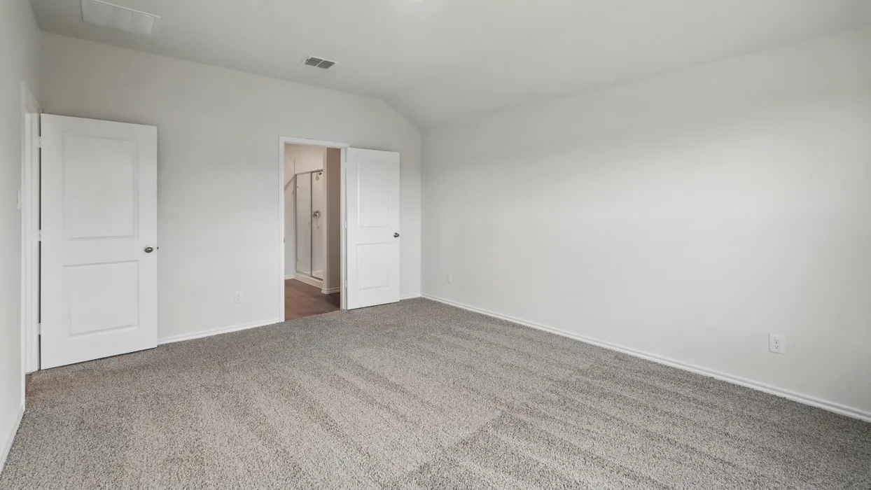 Neutral wall color, vaulted ceiling, grey carpeting, white interior doors, recessed lighting