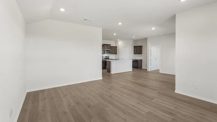 Wood-finish flooring throughout, recessed lighting, and white walls