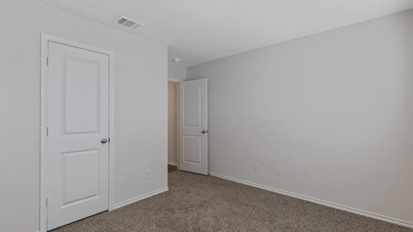 Light neutral wall paint, white trim, and neutral carpeting