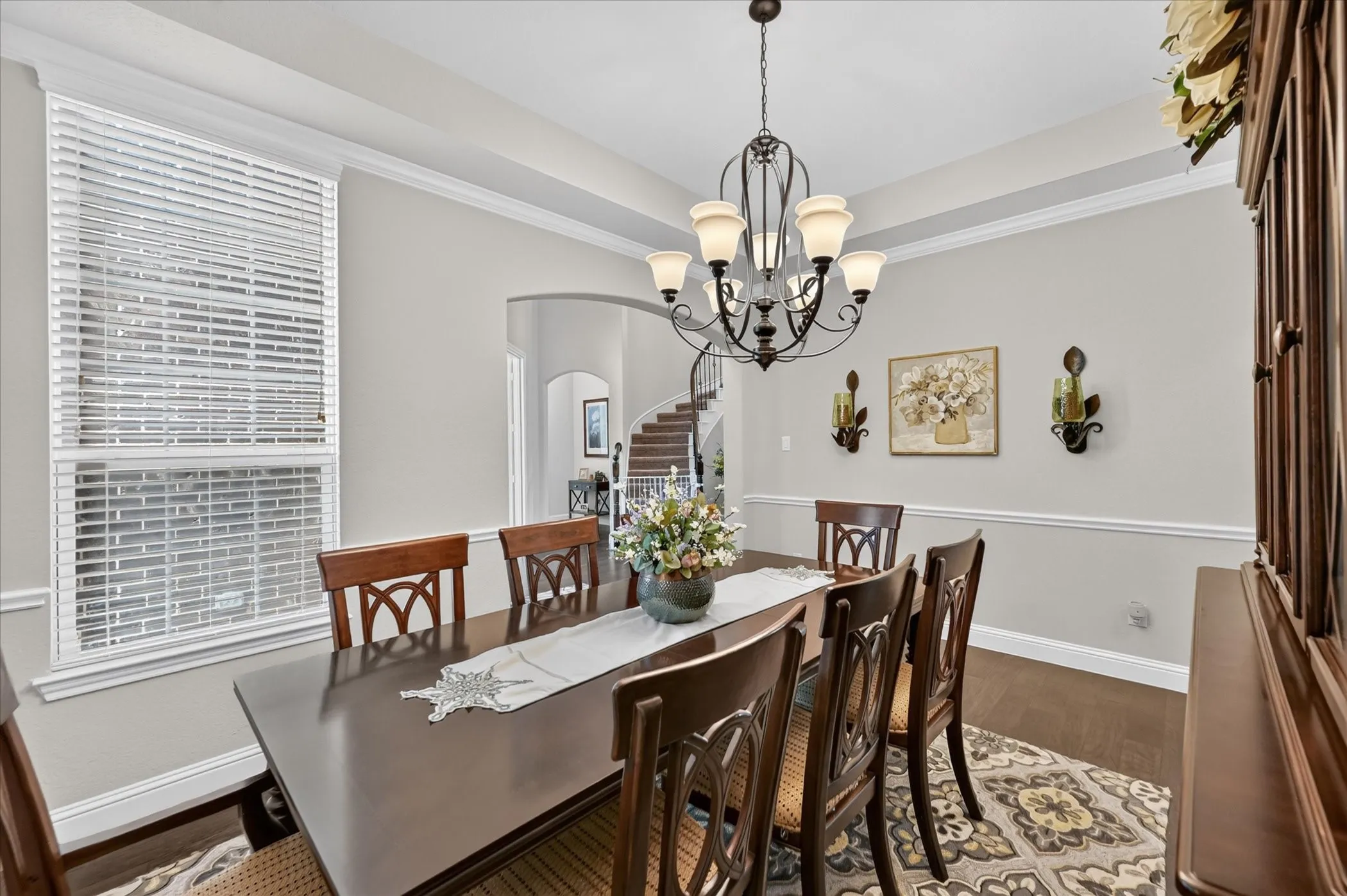 Tray ceiling with crown molding and a decorative chandelier
