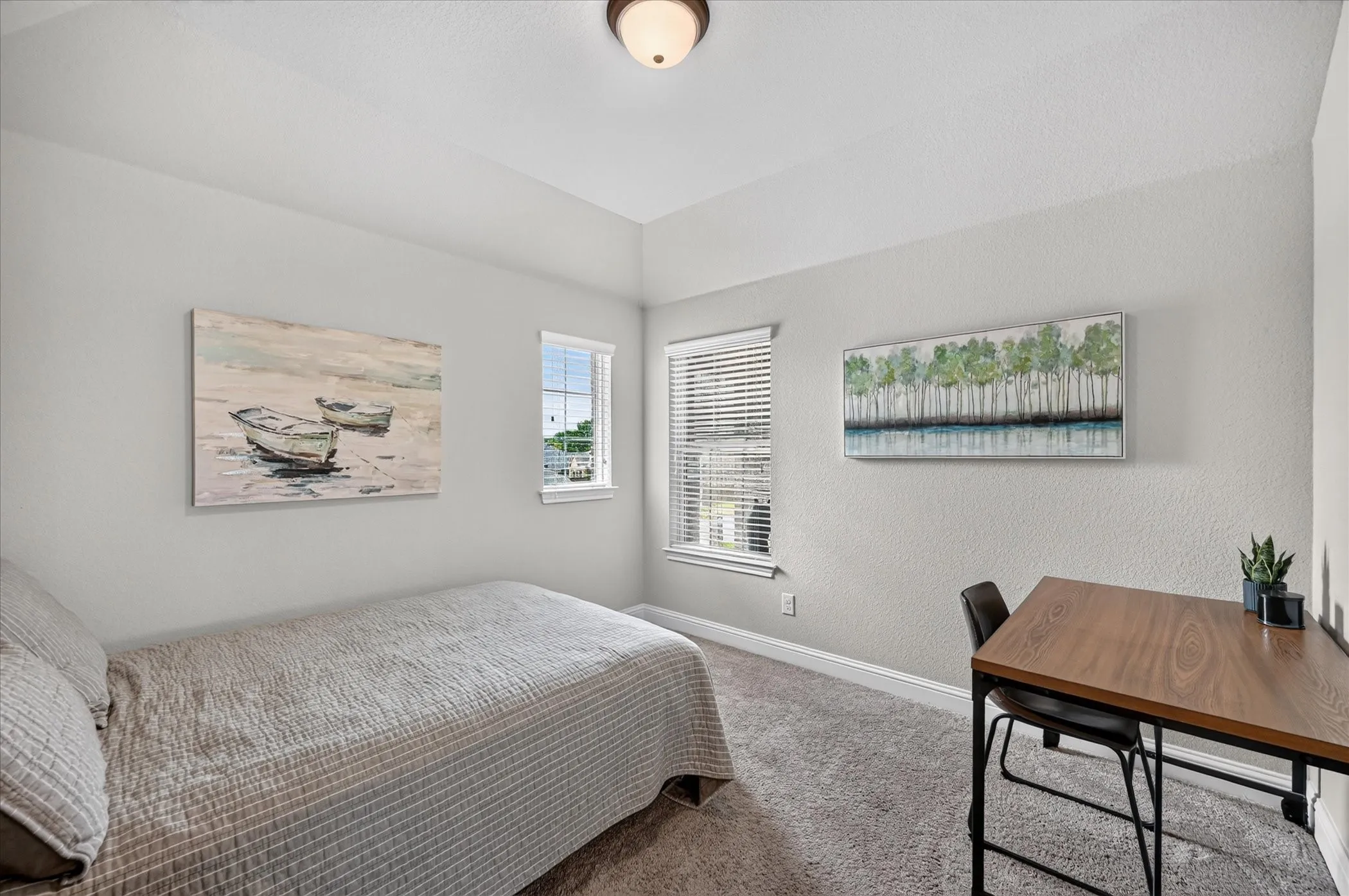 Bright secondary bedroom featuring carpet flooring, dual windows with plantation shutters, and soft recessed ceiling lighting
