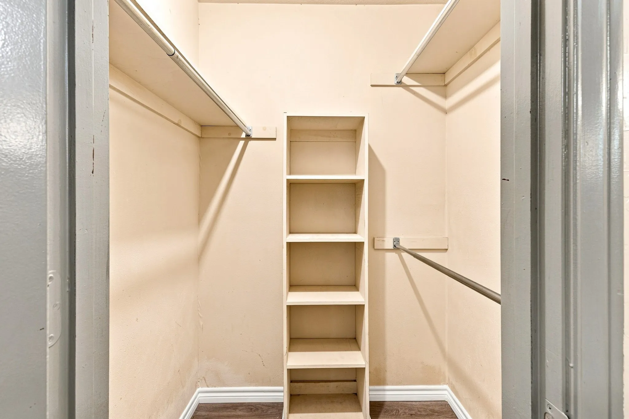 Built-in shelving unit, dual hanging rods, and integrated upper shelving