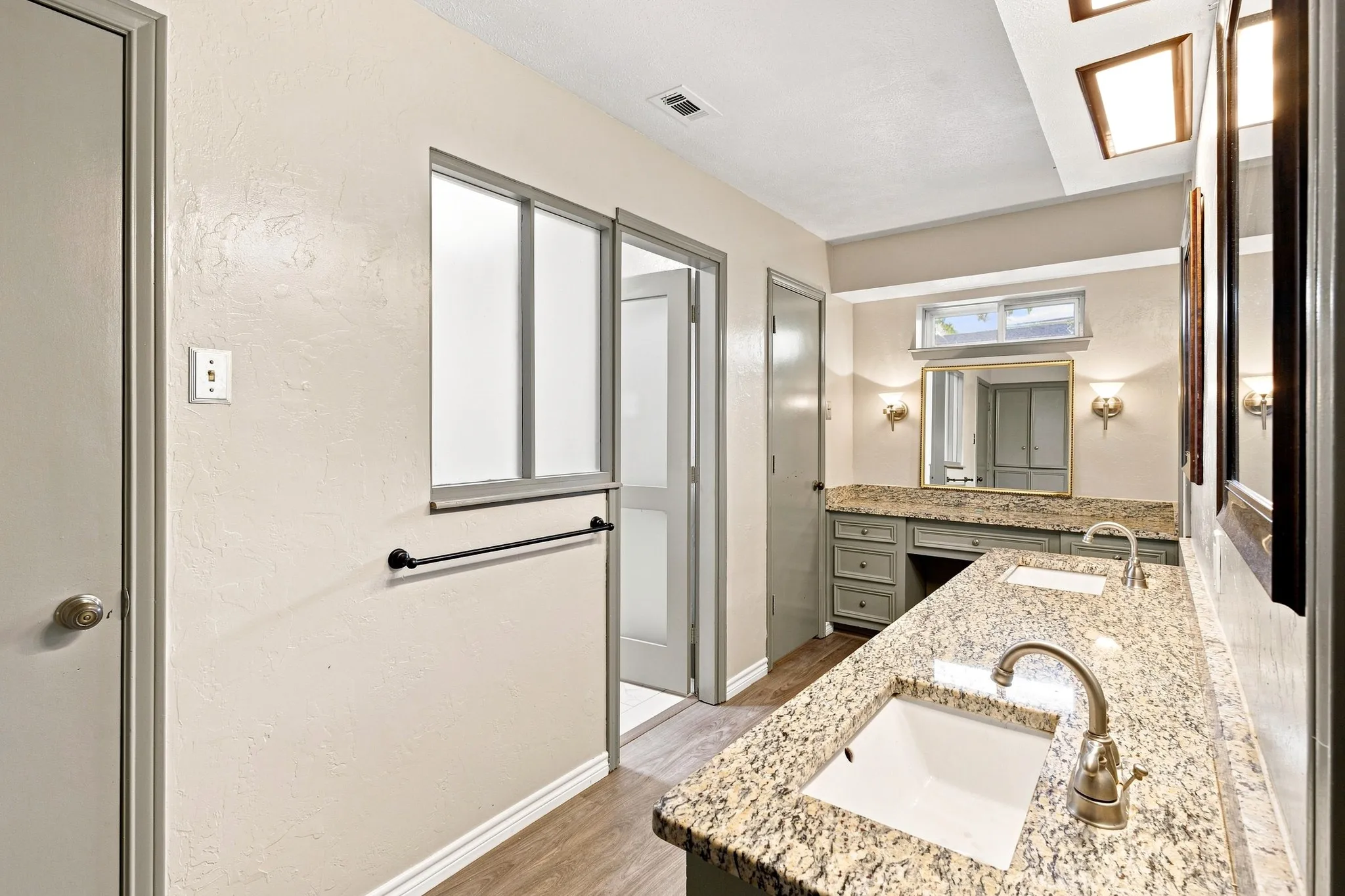 Dual vanity with stone-finish countertops and integrated sinks