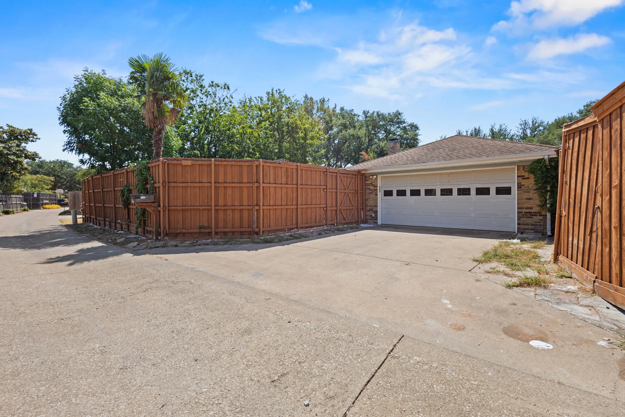 Attached two-car garage with a panel door and horizontal windows