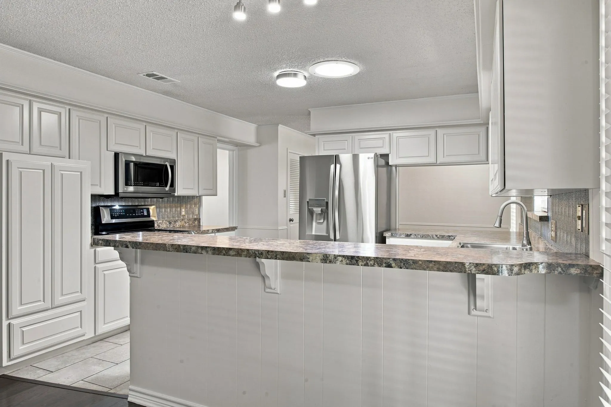White cabinetry and stainless steel appliances