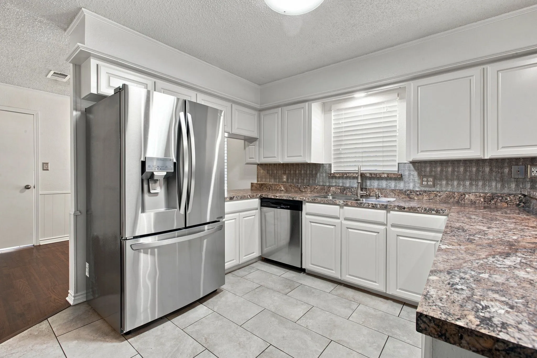 White cabinetry and stainless steel appliances