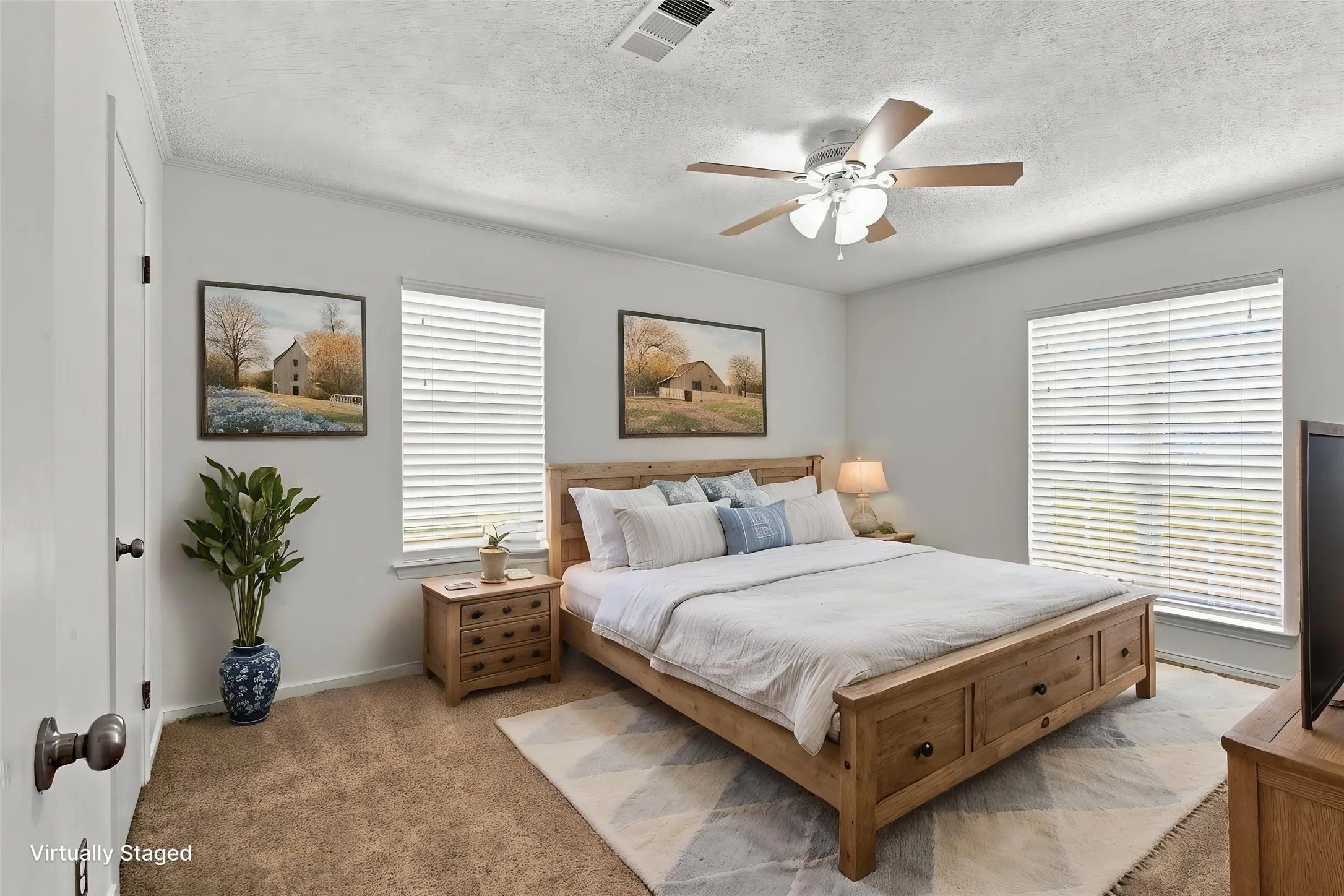 Bedroom with ceiling fan, two windows with blinds, and carpeted flooring