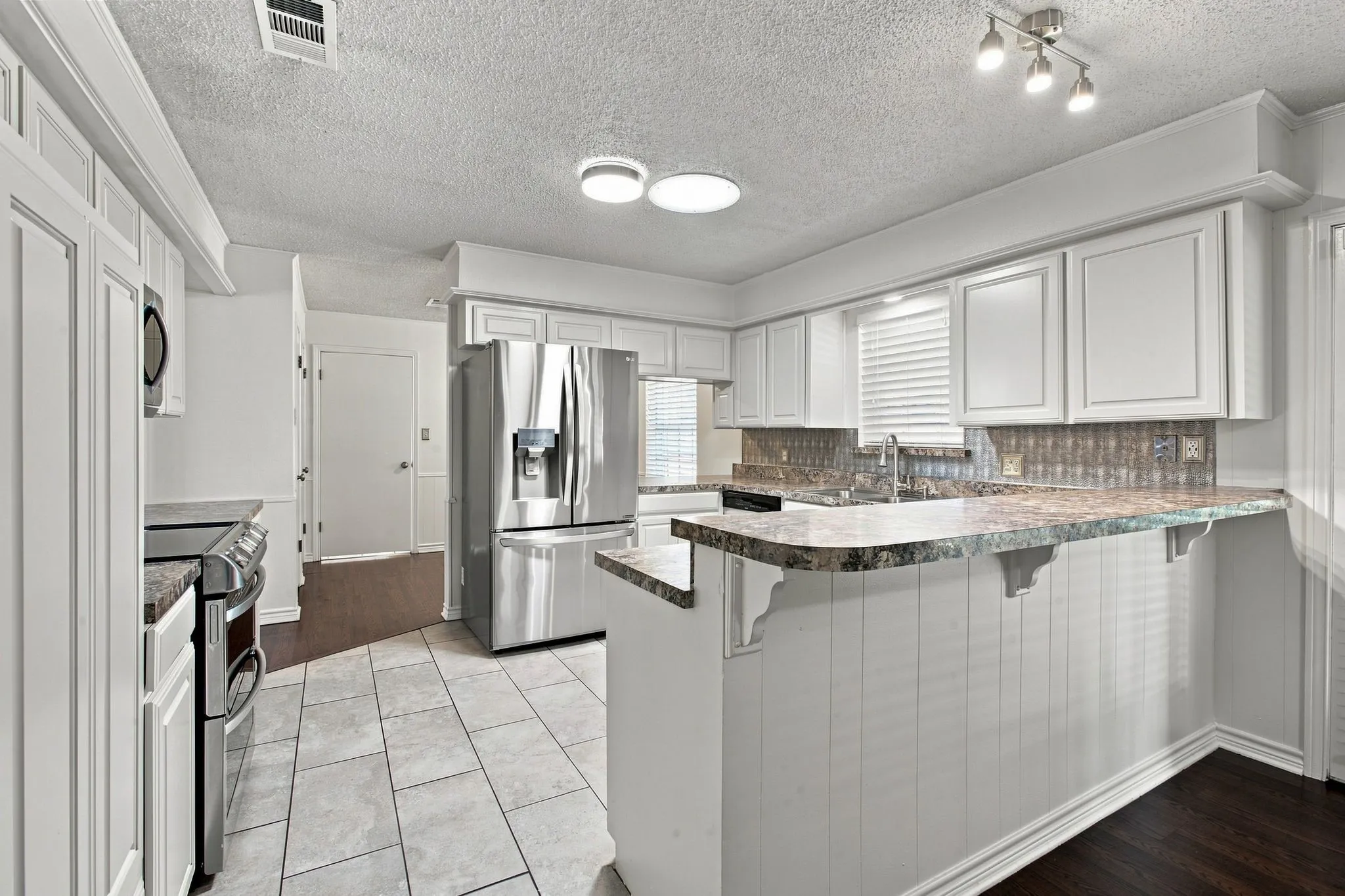 White cabinetry and stainless steel appliances