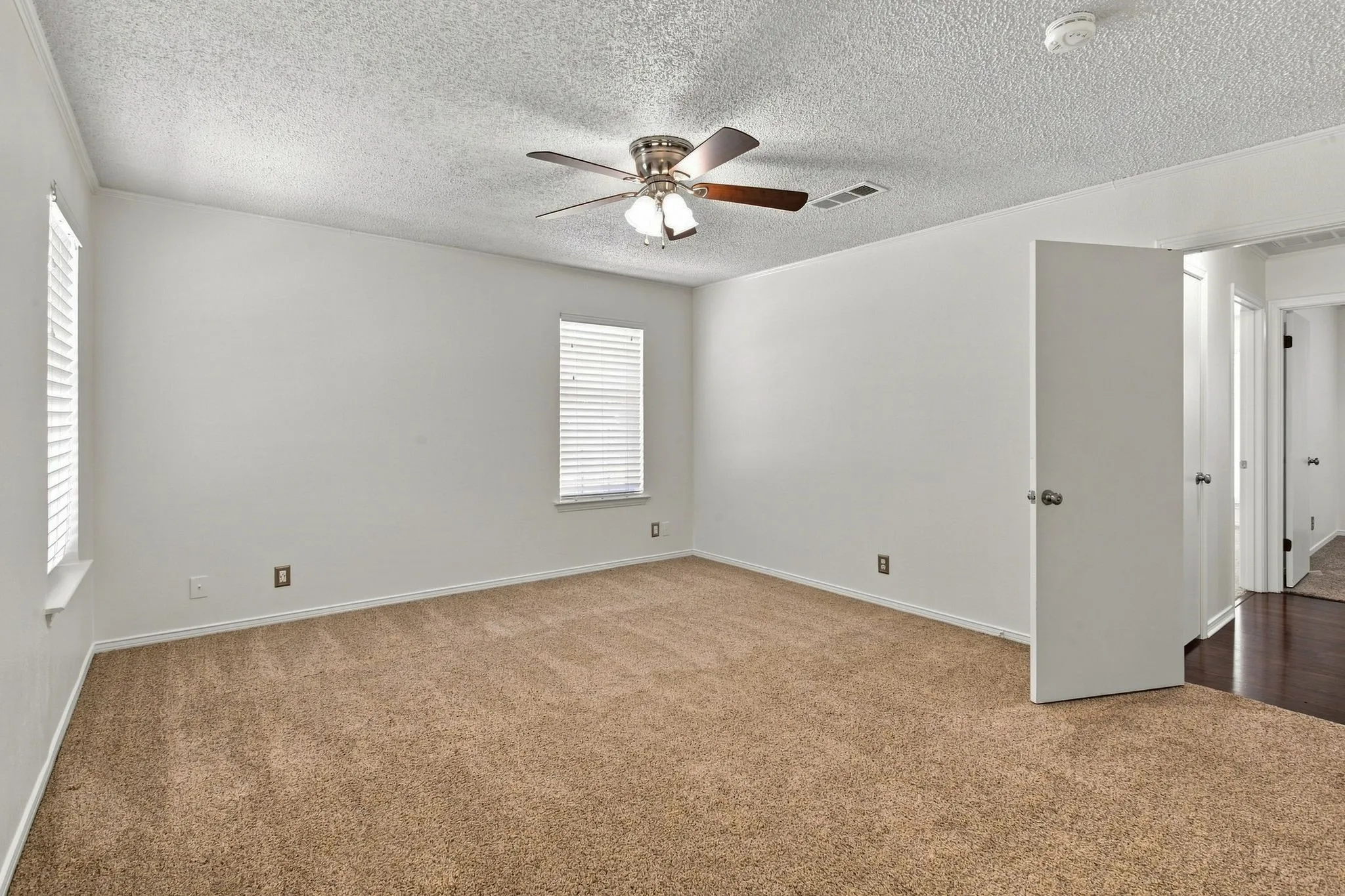 Bedroom with a ceiling fan and ensuite bathroom