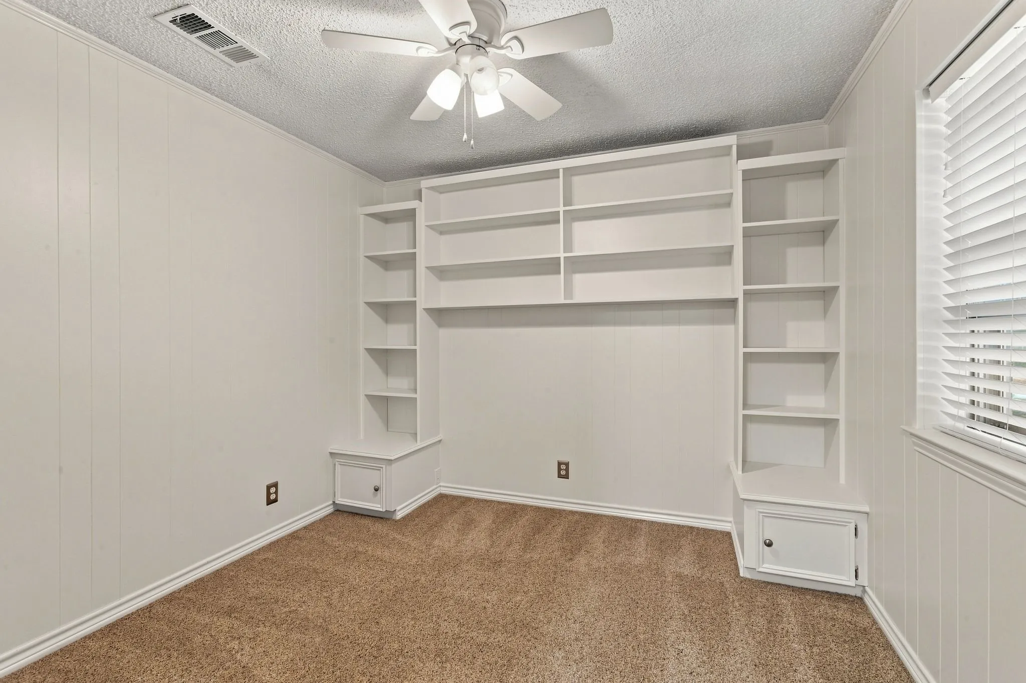 Built-in shelving and ceiling fan