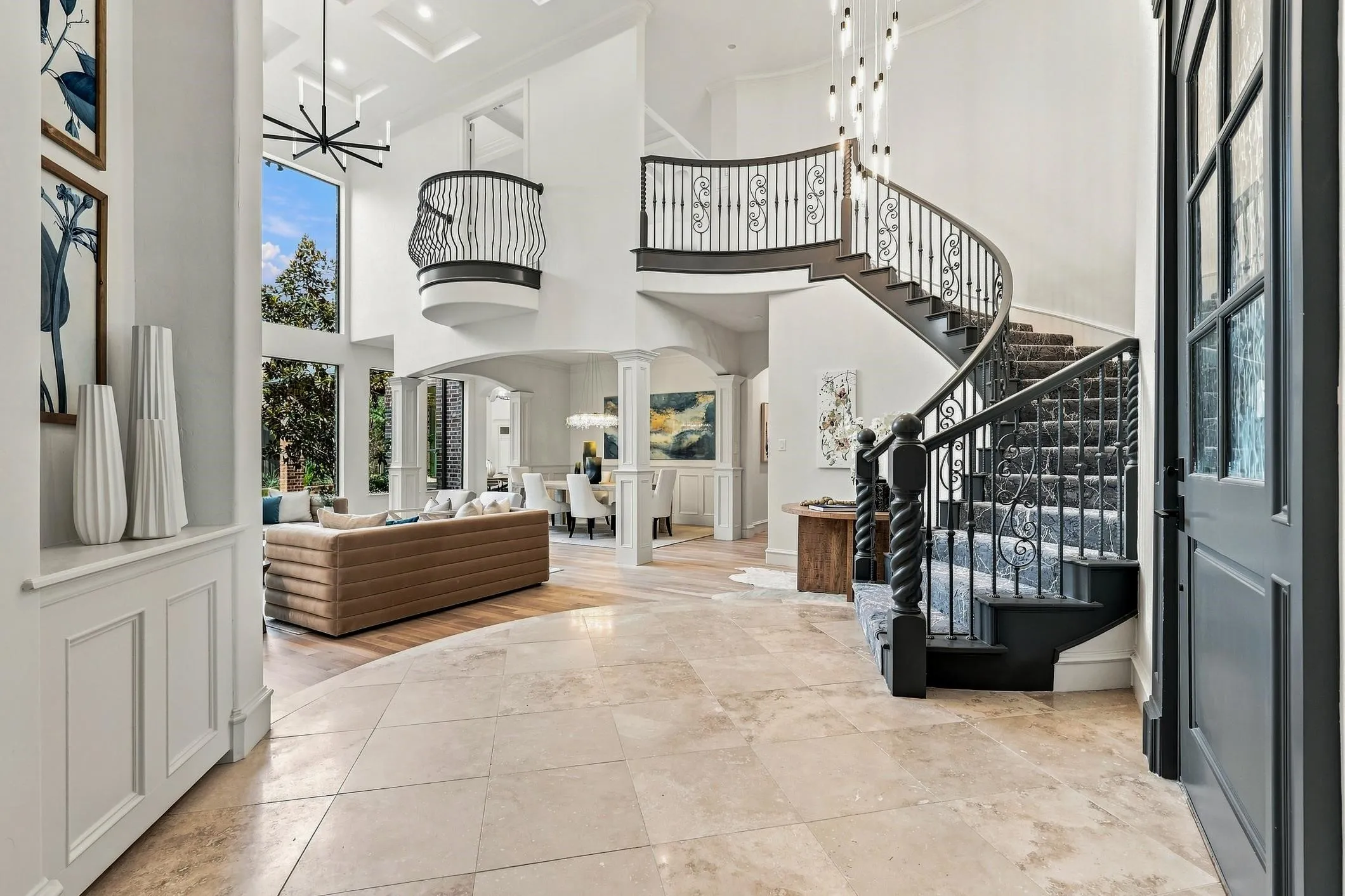 Wide open spaces upon entering you have a view of the spiral staircase with designer carpet, high ceilings, gorgeous fan and chandelier with new white oak hardwood flooring.