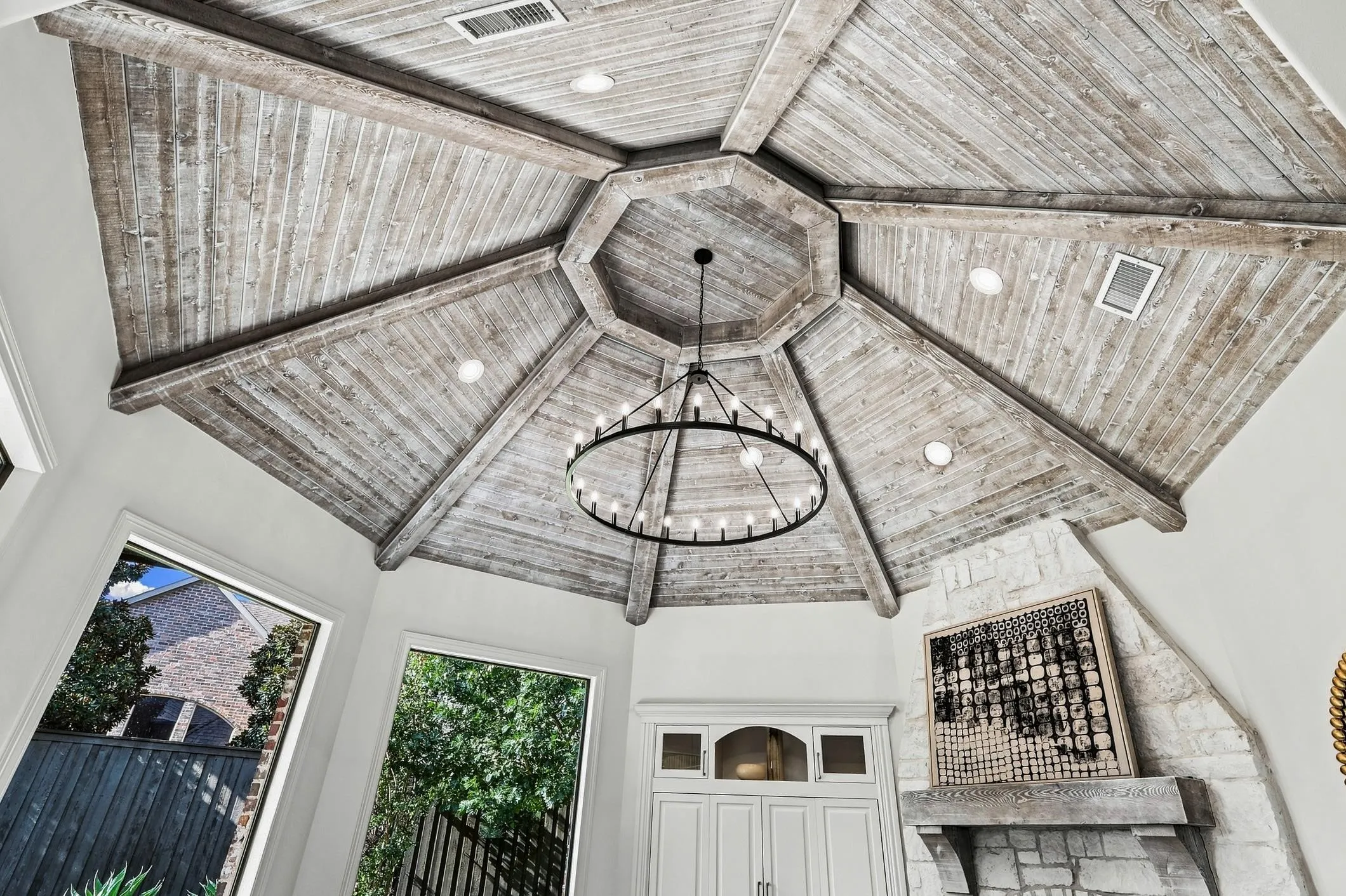 The ceiling in this room was meticulously hand trimmed with solid cedar wood and beams and custom stained to match the mantel columns. New can lighting and candelier brighten up this room!!!