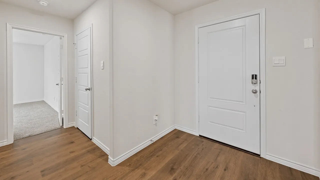 Wood-finish flooring, white paneled doors, recessed lighting, and light gray wall paint