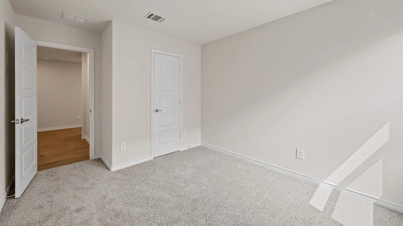 Neutral-toned wall finishes, light-colored carpeting, white interior doors, and modern door hardware