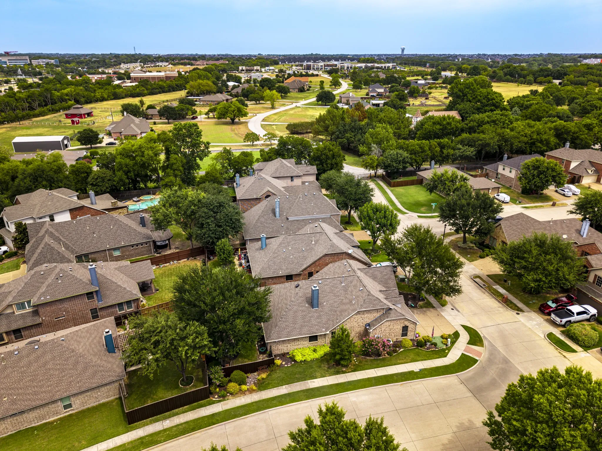 Residential neighborhood with varied rooflines, mature trees, and landscaped properties