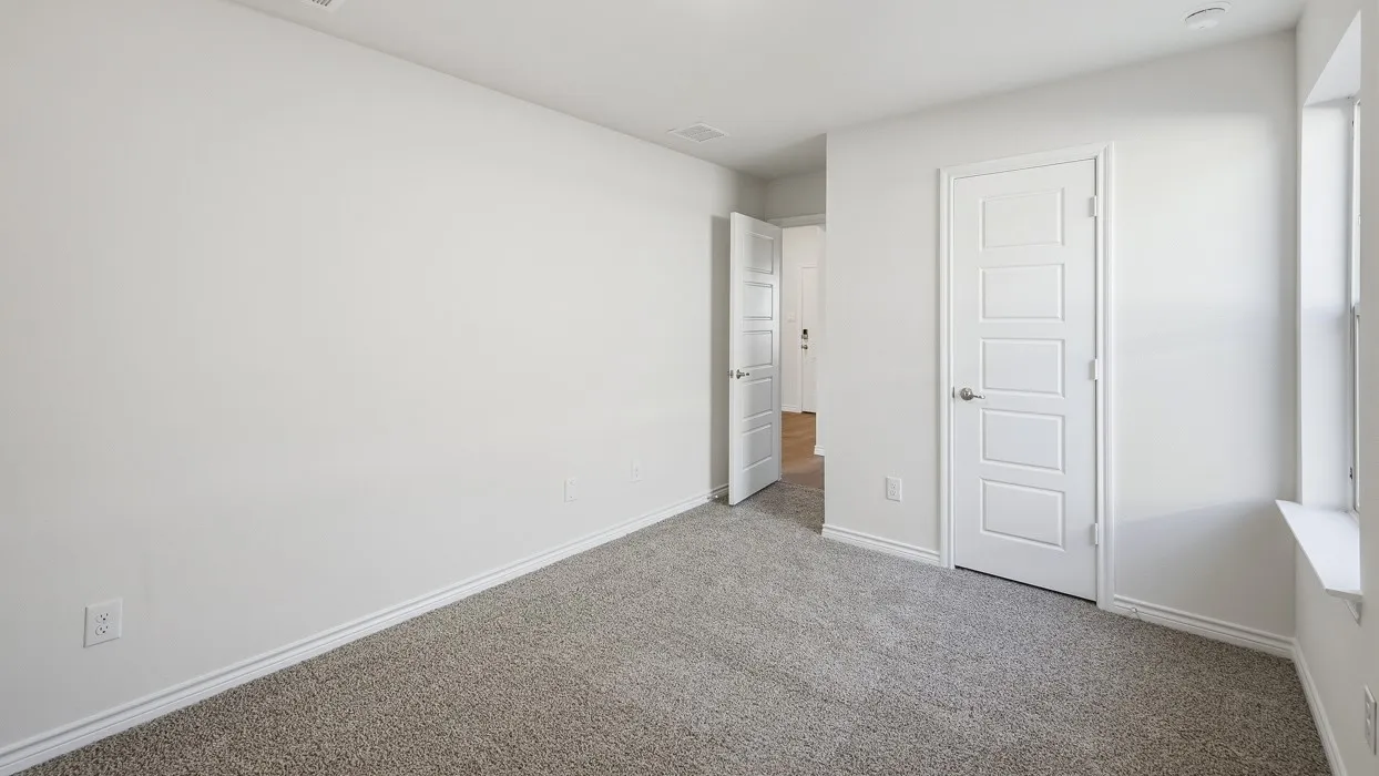 Recessed lighting, light gray carpeting, white trim, and a window with a deep sill