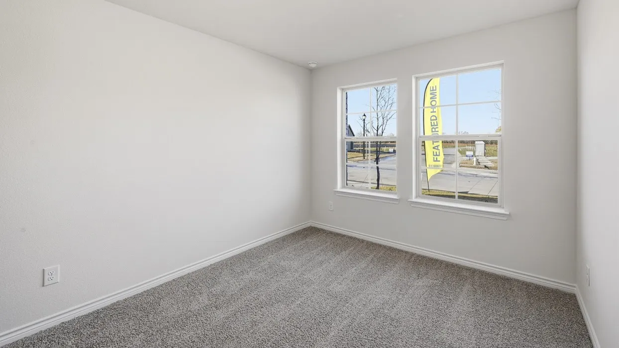 Light-colored textured walls, two windows with white frames, and gray carpeted flooring