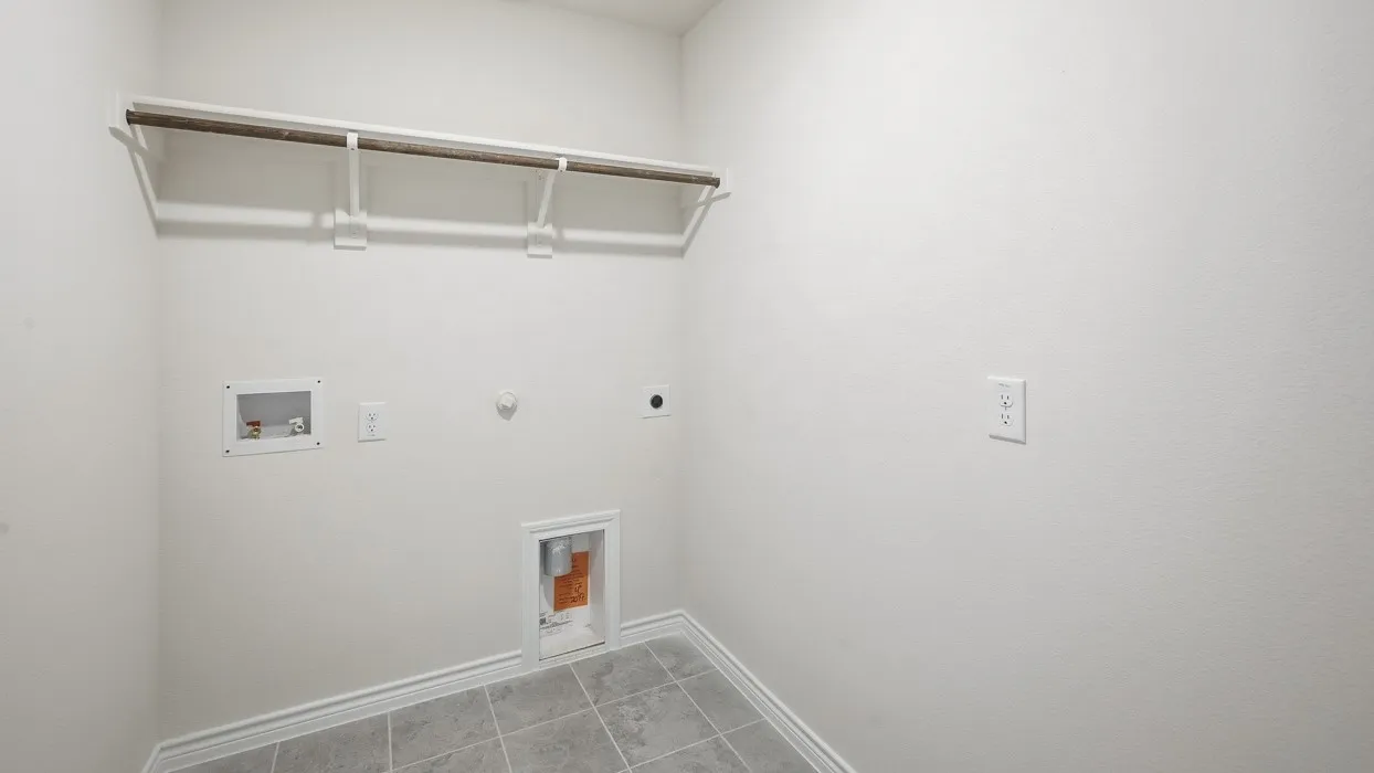 White wall finish, tile flooring, built-in shelving, plumbing hookups, and electrical outlets