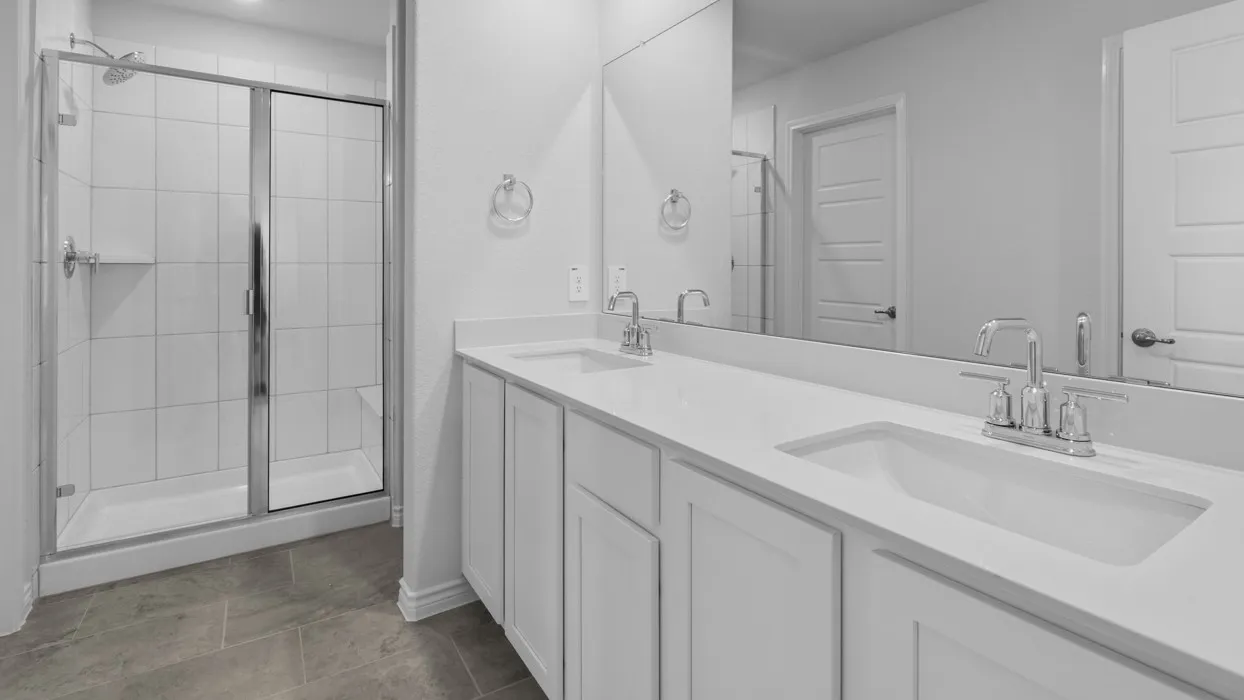 Dual vanity with integrated sinks, chrome fixtures, and a spacious countertop