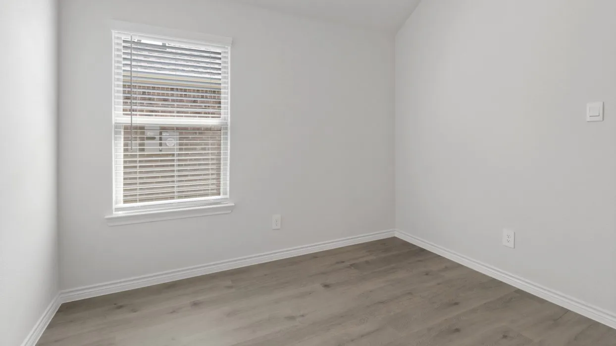 Wood-finish flooring, white walls, and a window with blinds