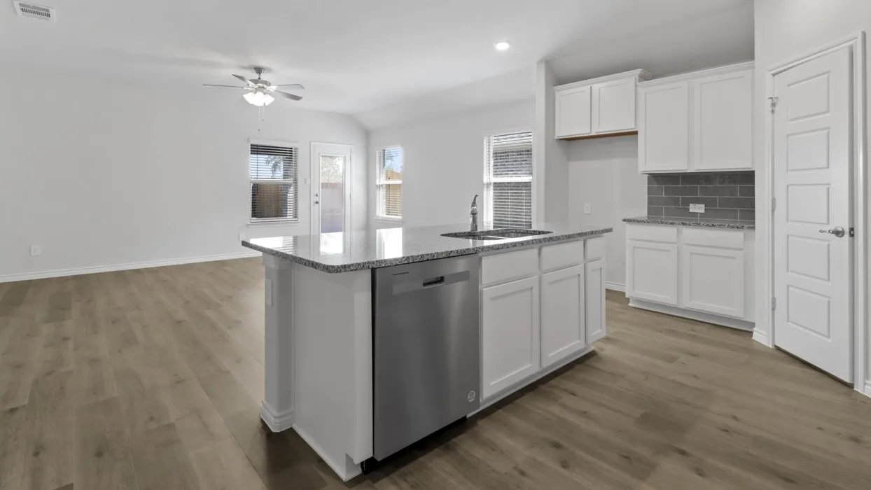 Kitchen island with granite countertop, stainless steel dishwasher, and undermount sink