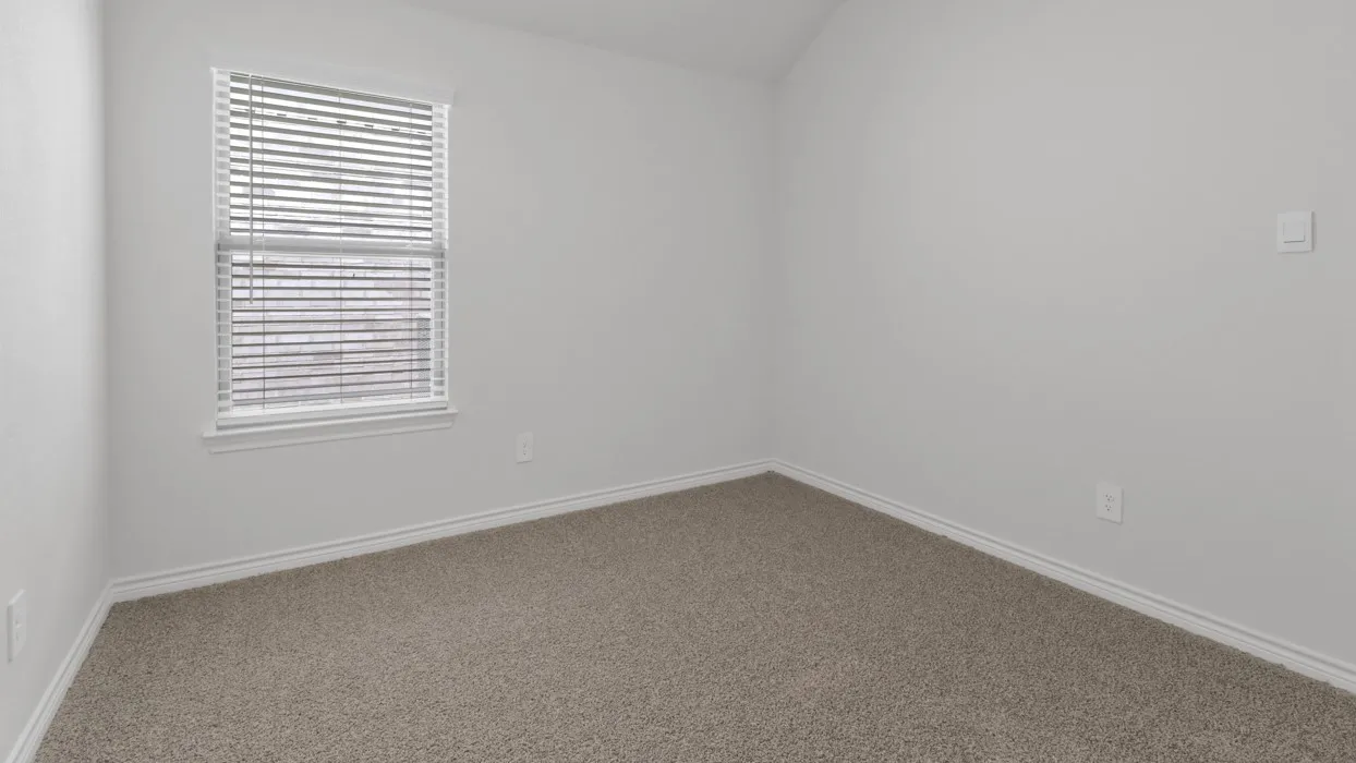 Carpeted flooring, white trim, and a window with blinds