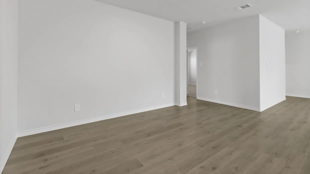 Spacious interior with neutral wall tones and wood-finish flooring