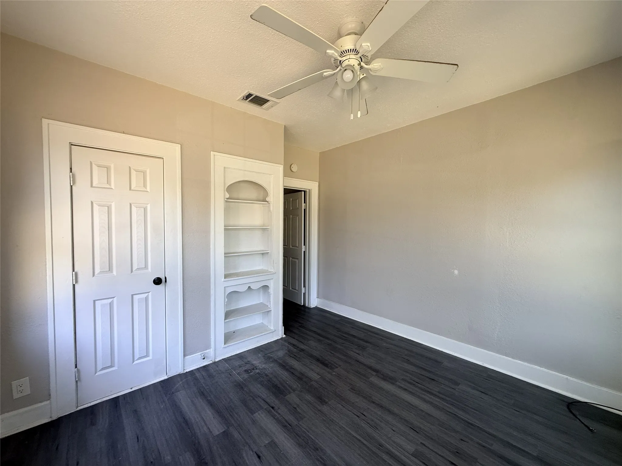 Dark wood-finish flooring with white trim