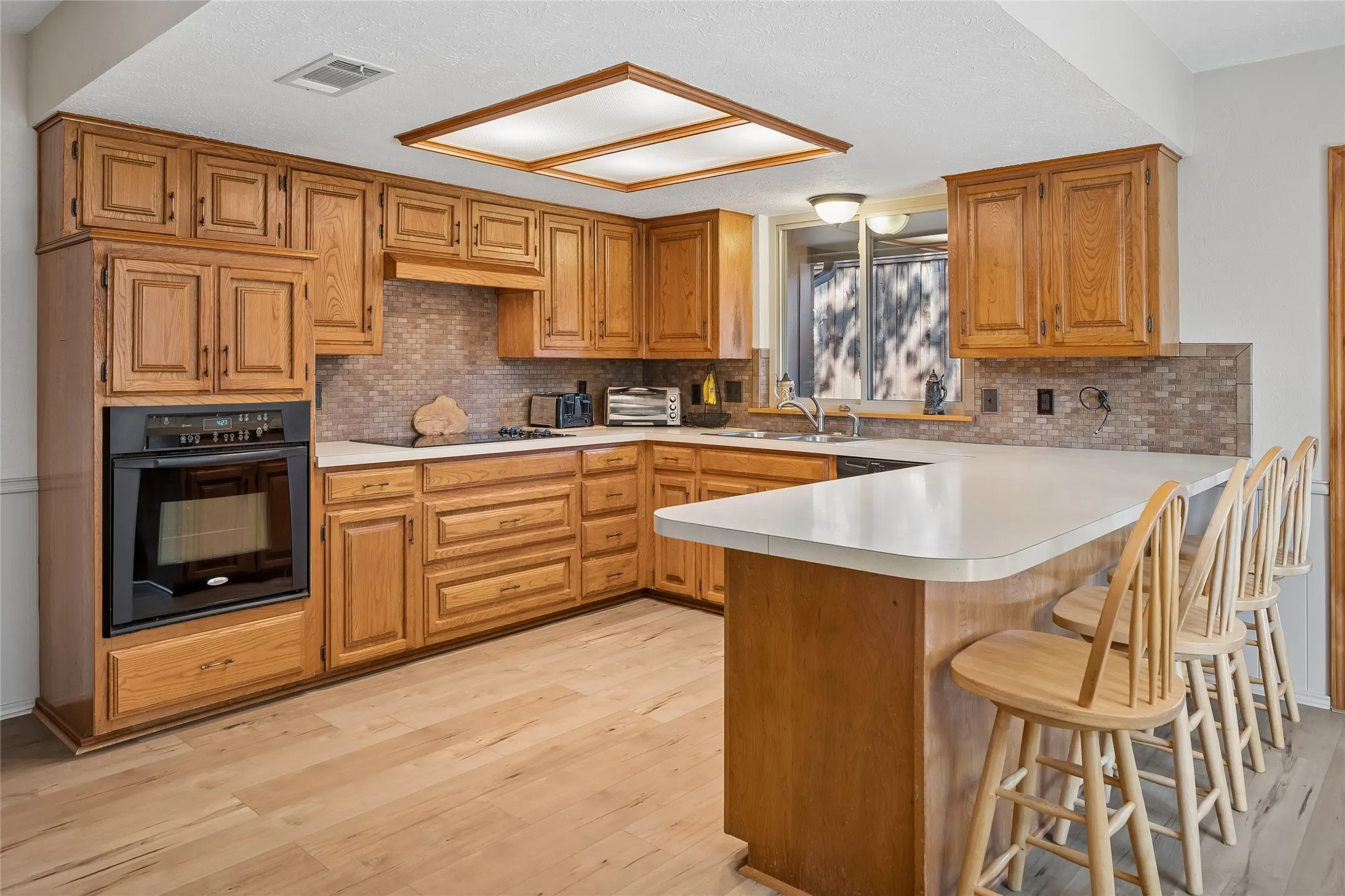 Plenty of cabinets with breakfast bar