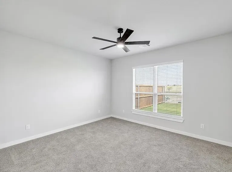 Plush carpeting, a contemporary ceiling fan with integrated lighting, window with horizontal blinds, and neutral wall tones