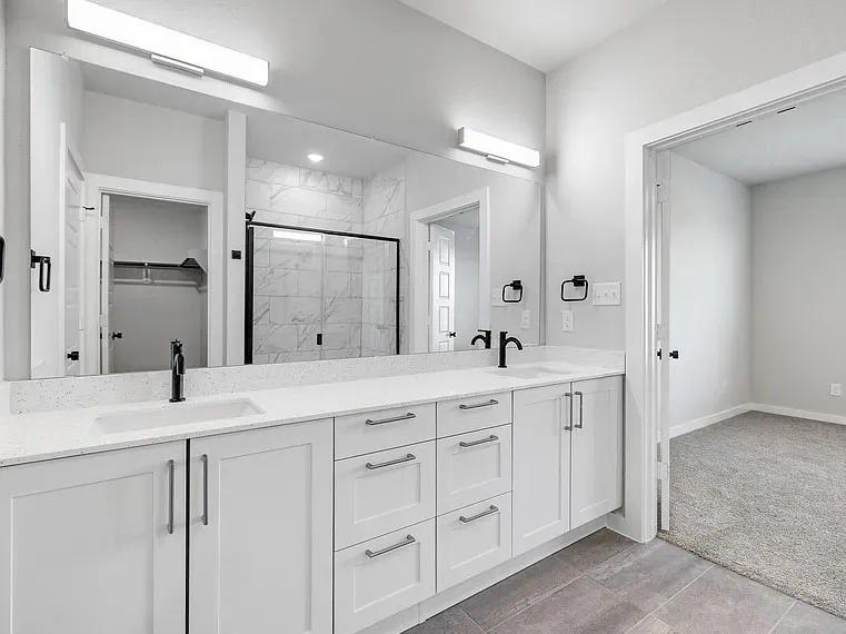 Dual vanity with white cabinetry and integrated sinks