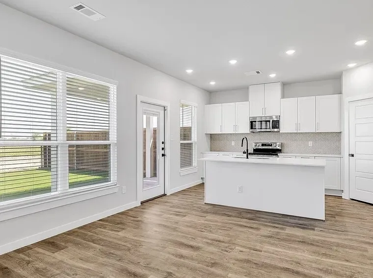 Modern kitchen with white cabinetry and an island