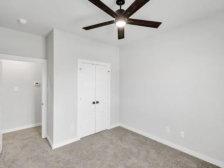 Recessed lighting, ceiling fan with light fixture, carpeted flooring, and paneled bifold doors