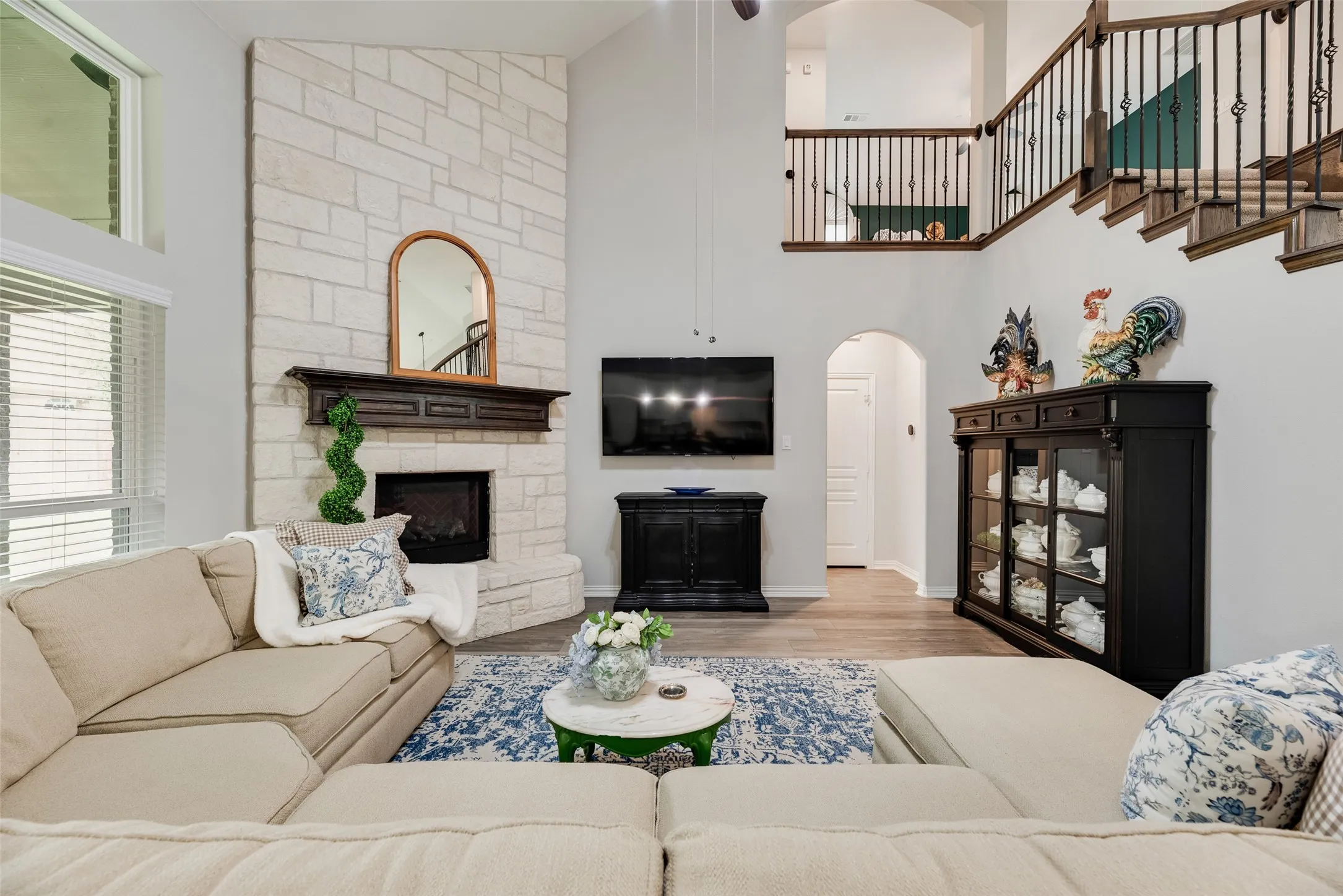 Tall ceilings throughout and a floor to ceiling stone gas log fireplace