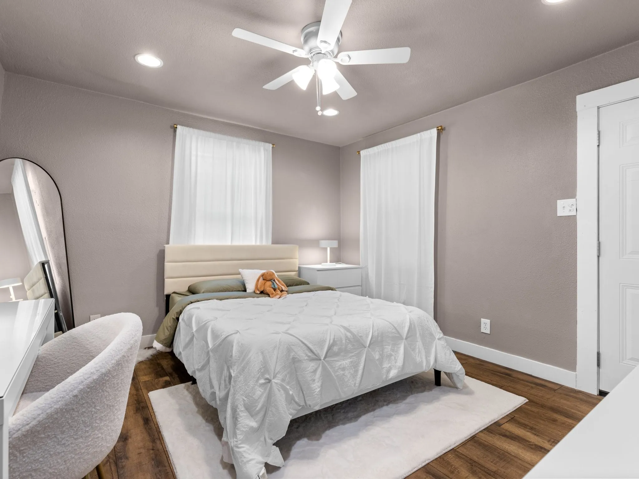 Recessed lighting, ceiling fan, wood-finish flooring, and white trim