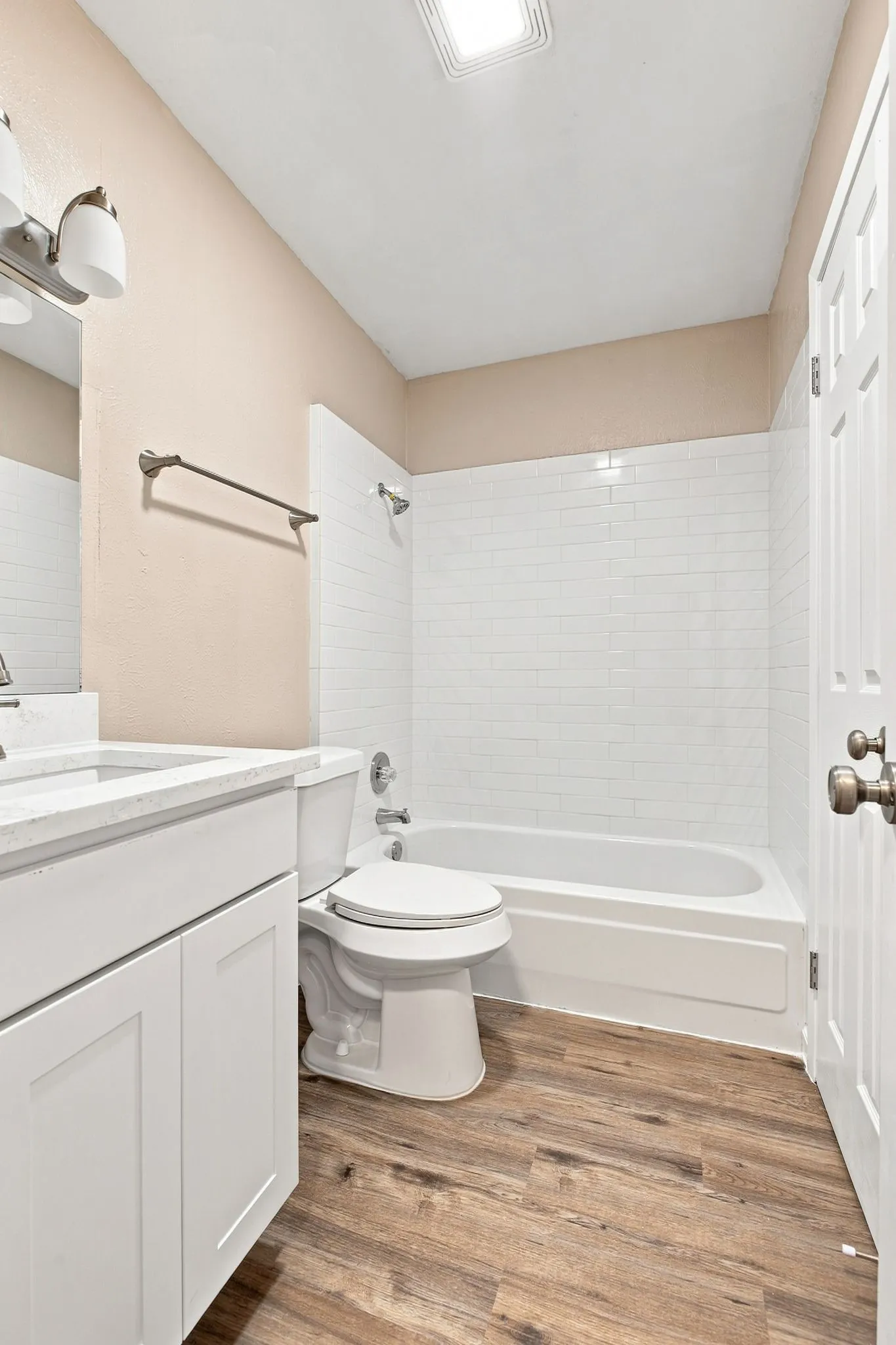 White shaker cabinetry with a stainless steel sink and appliance