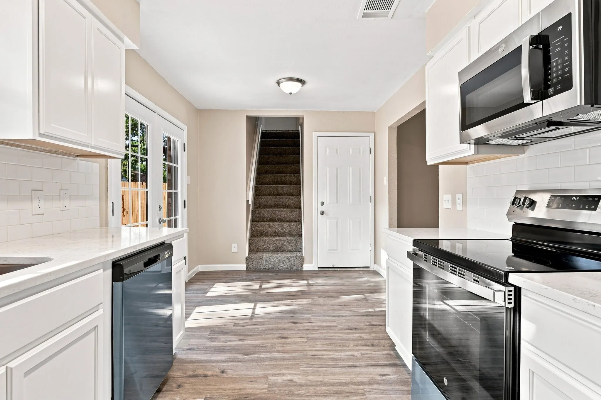 Neutral wall color, carpet flooring, ceiling fan, and white paneled doors