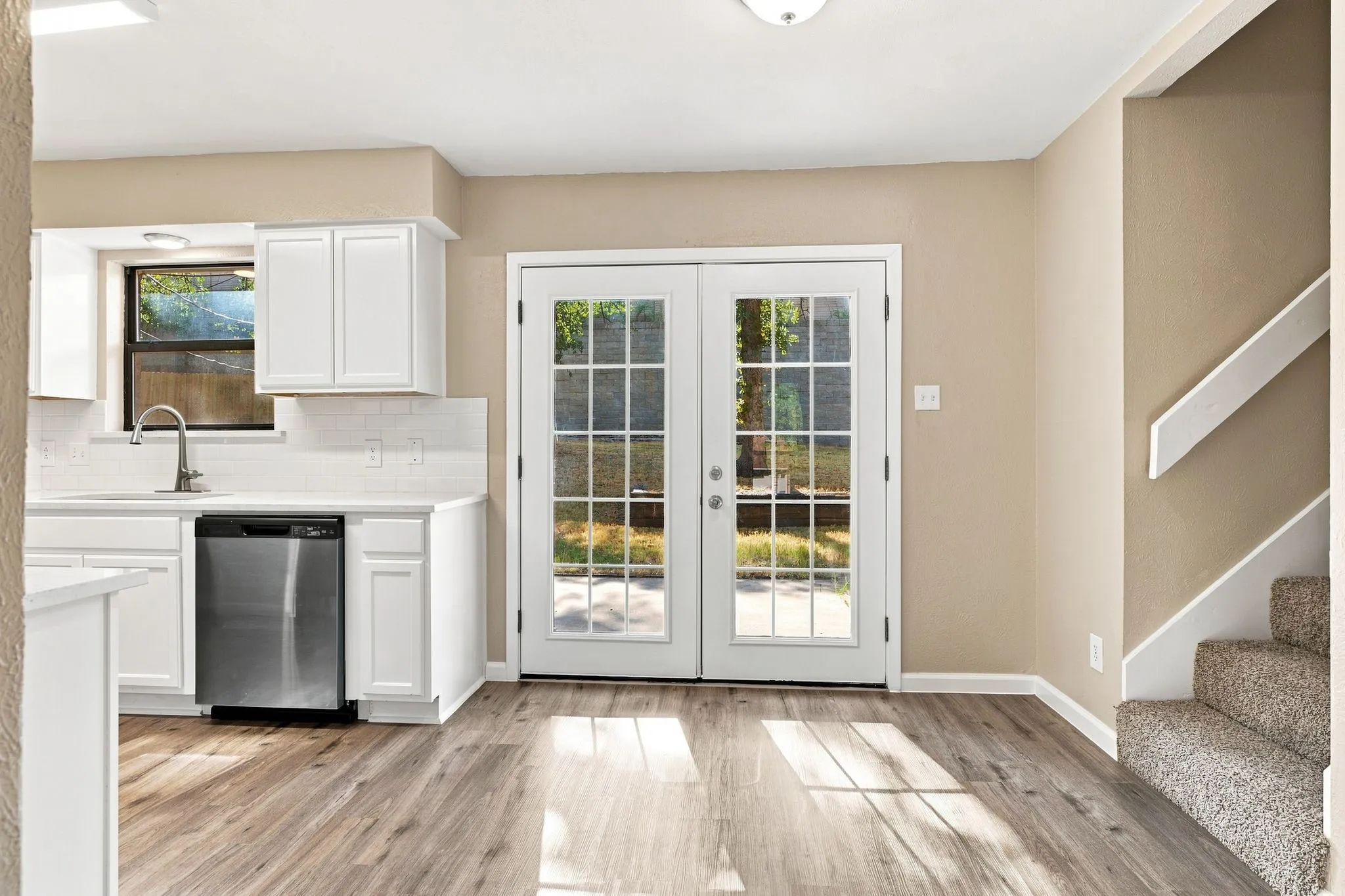 Carpeted flooring, neutral wall tones, ceiling fan with integrated lighting, and a window