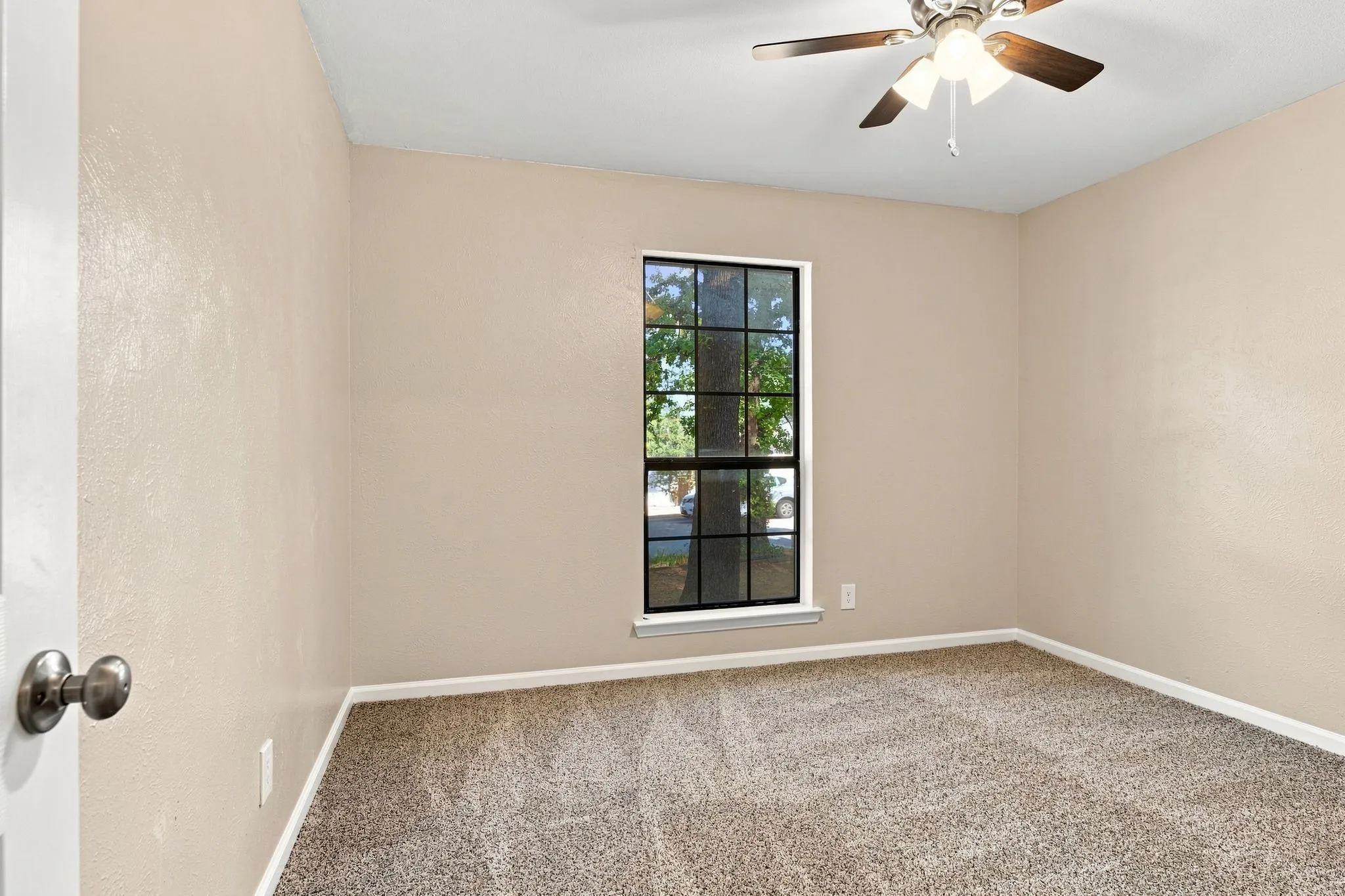 Neutral-toned walls complement the textured carpeting